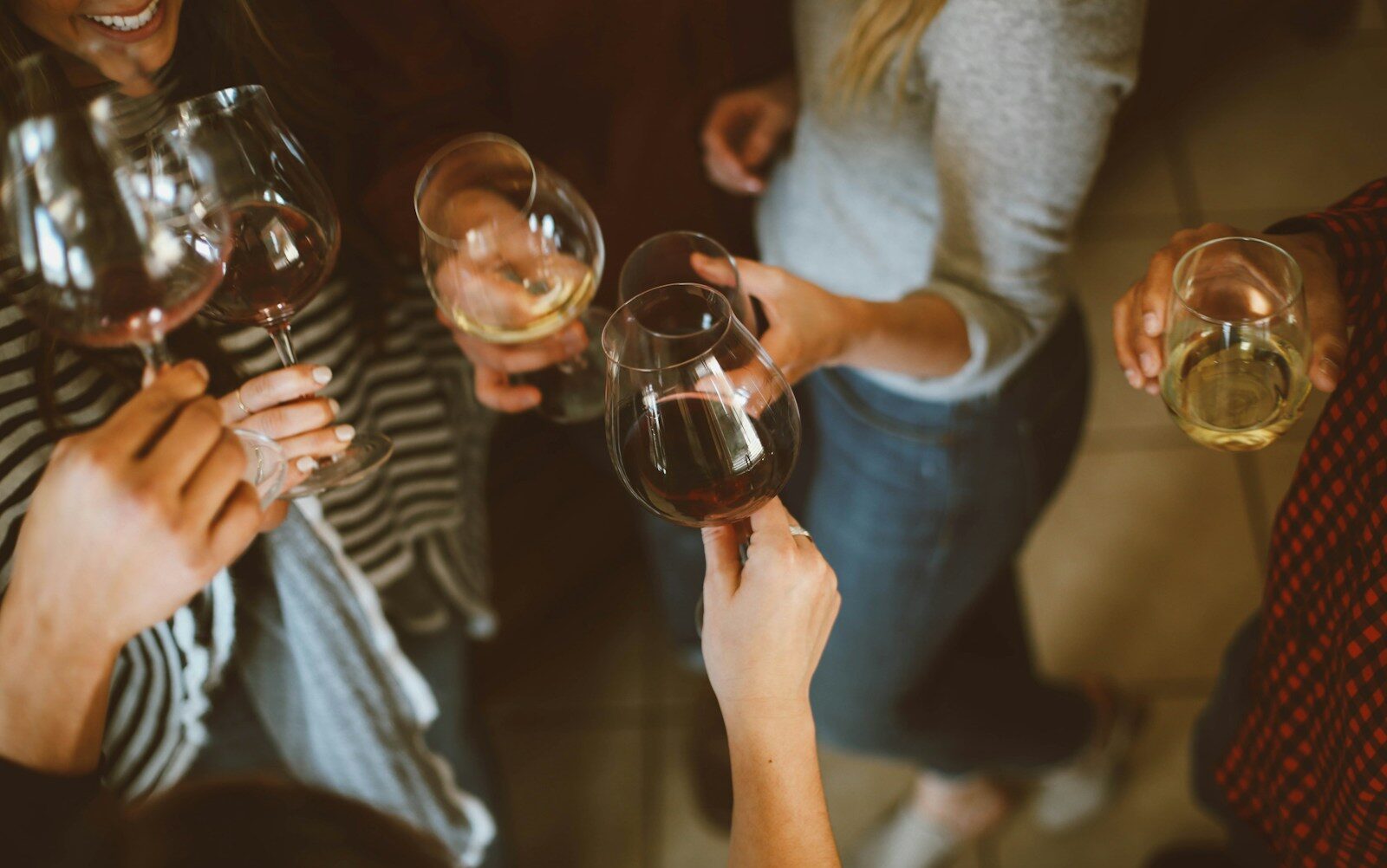 group of people tossing wine glass
